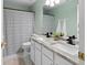 Bathroom featuring double sinks, white cabinets, and black and white shower curtain at 3321 Spindletop Nw Dr, Kennesaw, GA 30144