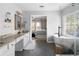 Bright bathroom featuring a soaking tub, glass shower, and double vanity with granite countertops at 3321 Spindletop Nw Dr, Kennesaw, GA 30144
