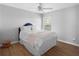 Bright bedroom with hardwood floors, white walls, and natural light from a window at 3321 Spindletop Nw Dr, Kennesaw, GA 30144