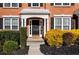 Inviting front porch with black door, manicured shrubs, and a 'hello' welcome mat at 3321 Spindletop Nw Dr, Kennesaw, GA 30144