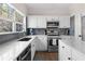 Bright kitchen featuring marble countertops, stainless steel appliances, and white cabinets at 3321 Spindletop Nw Dr, Kennesaw, GA 30144