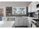 Modern kitchen features stainless steel appliances, grey tile backsplash and ample white cabinets at 3321 Spindletop Nw Dr, Kennesaw, GA 30144