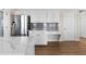 Bright kitchen boasts stainless steel fridge, white cabinets, grey backsplash and counter space at 3321 Spindletop Nw Dr, Kennesaw, GA 30144