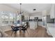 Eat-in kitchen featuring white cabinets, stainless steel appliances, and a light fixture above the dining table at 3321 Spindletop Nw Dr, Kennesaw, GA 30144