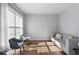 Cozy living room with hardwood floors, modern furniture, and large window with blinds at 3321 Spindletop Nw Dr, Kennesaw, GA 30144