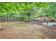 Spacious backyard with a wooden fence, grassy area, and an inviting deck with a fire pit at 2533 Semmes St, East Point, GA 30344