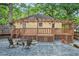 Backyard view with a deck, pergola, and gravel area featuring a charming fire pit with chairs at 2533 Semmes St, East Point, GA 30344