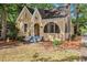 Charming brick home featuring a gabled roof, arched entryway, and well-maintained front yard at 2533 Semmes St, East Point, GA 30344