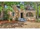 Charming brick home featuring a gabled roof, arched entryway, and well-maintained front yard at 2533 Semmes St, East Point, GA 30344
