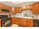 Functional kitchen with wood cabinets, stainless steel microwave, and gas range at 2533 Semmes St, East Point, GA 30344