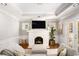 Cozy living room with a brick fireplace, white trim, hardwood floors, and large windows at 2533 Semmes St, East Point, GA 30344