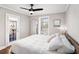 Comfortable bedroom with hardwood floors, ceiling fan, and door to outdoor space at 2533 Semmes St, East Point, GA 30344