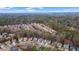 An expansive aerial view captures a well-planned neighborhood surrounded by lush, green trees at 1050 Westwell Run, Alpharetta, GA 30022