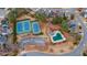 Aerial shot showcasing a community pool and tennis courts surrounded by lush trees in a residential neighborhood at 1050 Westwell Run, Alpharetta, GA 30022