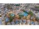 Overhead view of a neighborhood with tennis courts, a pool, and well-manicured lawns surrounding cozy homes at 1050 Westwell Run, Alpharetta, GA 30022