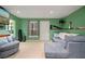 Basement living room with large TV, comfortable seating, and a view to the outdoors at 1050 Westwell Run, Alpharetta, GA 30022