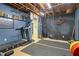 Open basement workout area with exposed ceiling and wall decorations at 1050 Westwell Run, Alpharetta, GA 30022