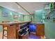 Basement bar area features a wine cooler, countertop, and shelving at 1050 Westwell Run, Alpharetta, GA 30022