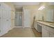 Bright bathroom with a walk-in shower, double vanity, and neutral tile flooring throughout at 1050 Westwell Run, Alpharetta, GA 30022
