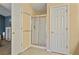 Bathroom boasting a glass-enclosed shower with a sliding door and neutral tile flooring at 1050 Westwell Run, Alpharetta, GA 30022