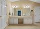 Bathroom featuring a dual sink vanity, granite counters, a large mirror, and ample lighting at 1050 Westwell Run, Alpharetta, GA 30022