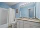 Bright bathroom featuring a double vanity with granite countertops and shower-tub combination at 1050 Westwell Run, Alpharetta, GA 30022
