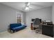 Bedroom featuring a modern futon, desk setup, and a neutral-toned carpeted floor at 1050 Westwell Run, Alpharetta, GA 30022