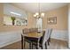 Charming dining room featuring modern lighting and open view to the kitchen area at 1050 Westwell Run, Alpharetta, GA 30022