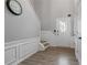 Light-filled entryway with paneled wall and staircase at 1050 Westwell Run, Alpharetta, GA 30022