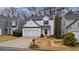 Welcoming two-story home featuring a double garage and neat landscaping at 1050 Westwell Run, Alpharetta, GA 30022