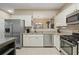 Modern kitchen featuring stainless steel appliances, granite countertops, and ample natural light at 1050 Westwell Run, Alpharetta, GA 30022