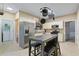 Bright eat-in kitchen with stainless steel appliances, modern lighting, and adjacent laundry room at 1050 Westwell Run, Alpharetta, GA 30022