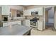 Well-lit kitchen with stainless appliances, granite counters, and an island, perfect for cooking at 1050 Westwell Run, Alpharetta, GA 30022