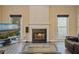 Inviting living room featuring a fireplace and large windows bringing in natural light at 1050 Westwell Run, Alpharetta, GA 30022