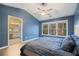 Cozy main bedroom showcasing a large window, a ceiling fan, and an en-suite bathroom at 1050 Westwell Run, Alpharetta, GA 30022