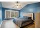 Spacious main bedroom featuring blue walls, a large window, and a contemporary ceiling fan at 1050 Westwell Run, Alpharetta, GA 30022