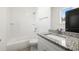 Bathroom with a tub and shower combo, a granite countertop vanity, a large mirror, and tiled floors at 1088 Wedgewood Nw Dr, Atlanta, GA 30318