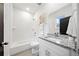 Bathroom with a tub and shower combo, a granite countertop vanity, a large mirror, and tiled floors at 1088 Wedgewood Nw Dr, Atlanta, GA 30318