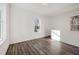 Bright bedroom featuring wood grain floors and natural light from two windows at 1088 Wedgewood Nw Dr, Atlanta, GA 30318