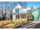 Charming two-story home with light blue siding, yellow front door, and a wooden porch at 1088 Wedgewood Nw Dr, Atlanta, GA 30318