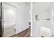 Upstairs hallway featuring a bathroom, a bedroom, luxury vinyl plank flooring, and white walls at 1088 Wedgewood Nw Dr, Atlanta, GA 30318