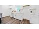 Modern kitchen features white cabinets, white countertops, stainless steel faucet, and luxury vinyl plank flooring at 1088 Wedgewood Nw Dr, Atlanta, GA 30318
