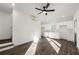 Open-concept living area with wood grain flooring, ceiling fan, and a view of the kitchen at 1088 Wedgewood Nw Dr, Atlanta, GA 30318