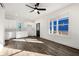 Open-concept living room features white cabinets, luxury vinyl plank flooring, and natural light from a large window at 1088 Wedgewood Nw Dr, Atlanta, GA 30318