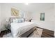 Main bedroom features a gray bed, luxury vinyl plank flooring, and natural light from two windows at 1088 Wedgewood Nw Dr, Atlanta, GA 30318
