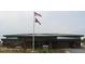 Simple one story building with brick exterior and flags waving in the distance at 11661 Mendenhall Ct, Hampton, GA 30228