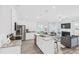 Contemporary kitchen and living room area with stainless appliances, granite counters, and modern furnishings at 11661 Mendenhall Ct, Hampton, GA 30228