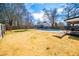 Spacious backyard with a pool, deck, and garden area, creating a perfect setting for outdoor living and recreation at 15 Russell Ln, Carrollton, GA 30116