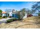 Exterior of a well-maintained house with stone accents, lush landscaping, and an additional outbuilding at 15 Russell Ln, Carrollton, GA 30116