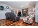 Cozy living room with hardwood floors, brick fireplace, and comfortable seating, perfect for relaxation at 15 Russell Ln, Carrollton, GA 30116